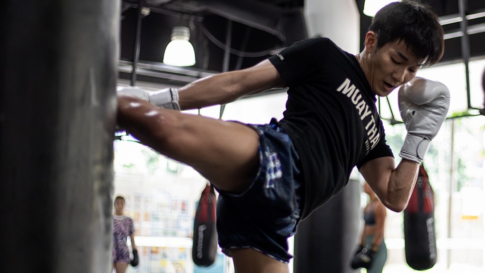 A student throwing a kick in a Muay Thai class in Evolve Far East Square.